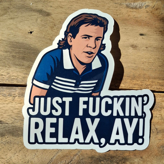 Sticker with a graphic of a person and text 'JUST FUCKIN' RELAX, AY!' on a wooden background